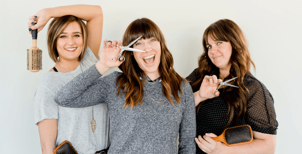 Three ladies posing with their tools of choice